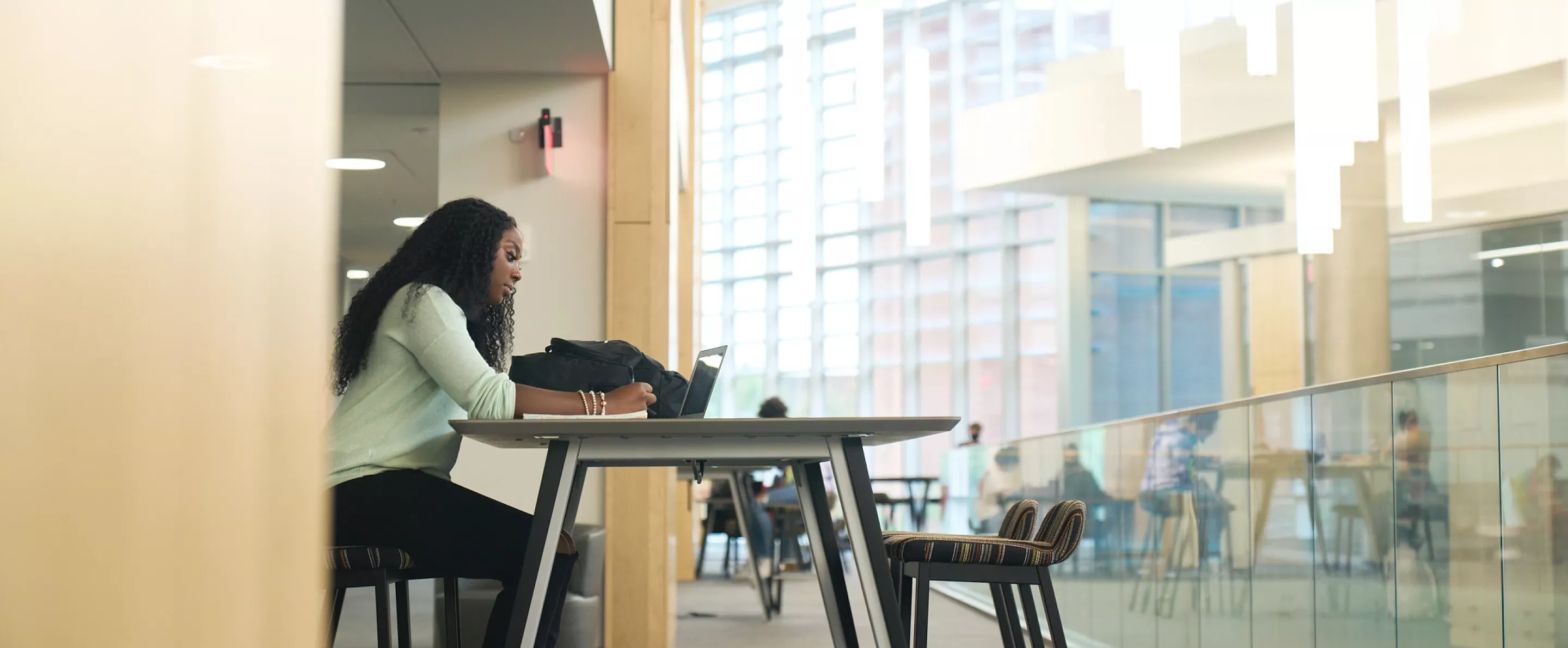 Student studying at a table in the BAB.