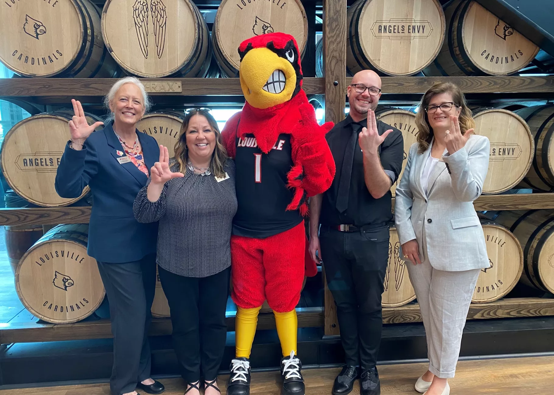 Executive Education Team posing with Louie the Cardinal