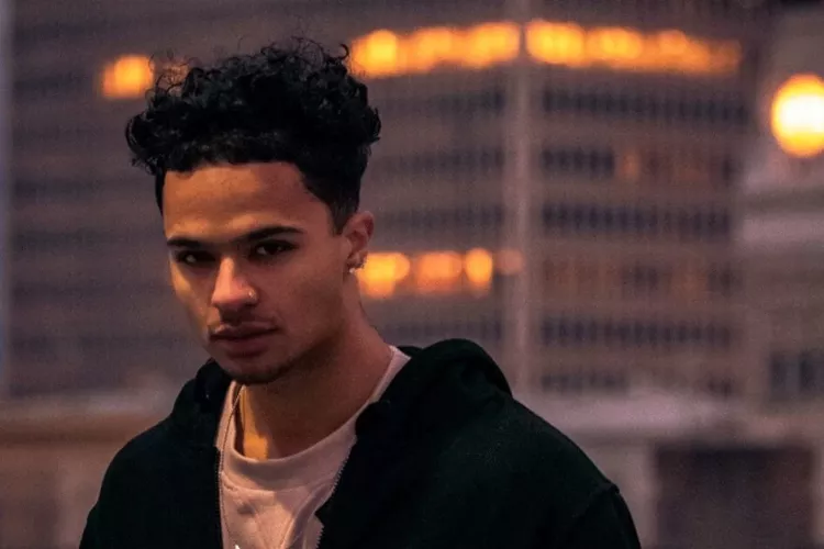 Headshot of a man outside at dusk.