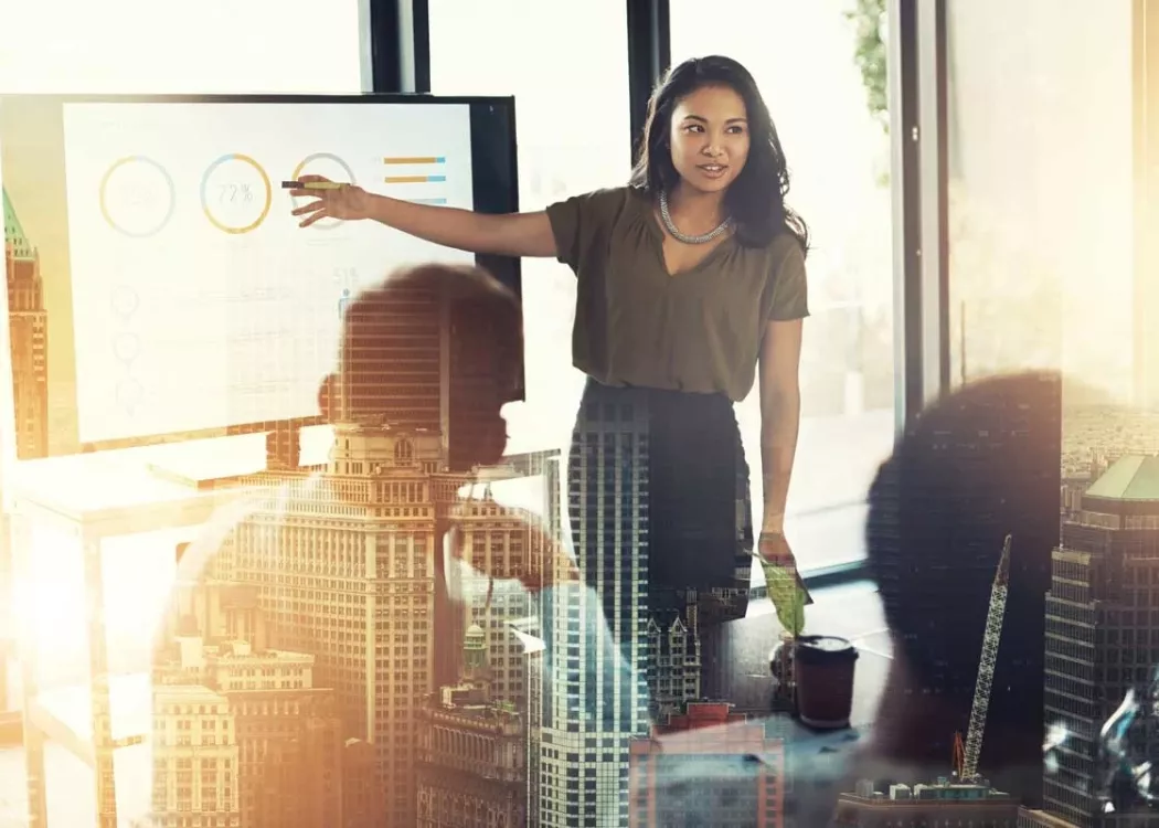 Woman presenting business charts to a group