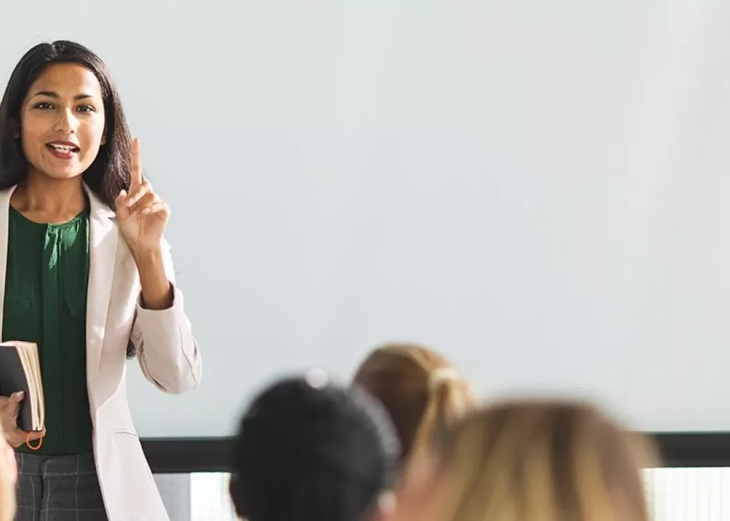 A woman in front of a classroom.