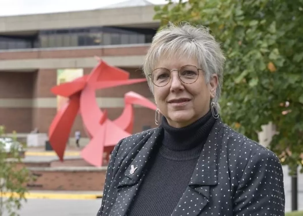 Kim Mallory in front of the College of Business