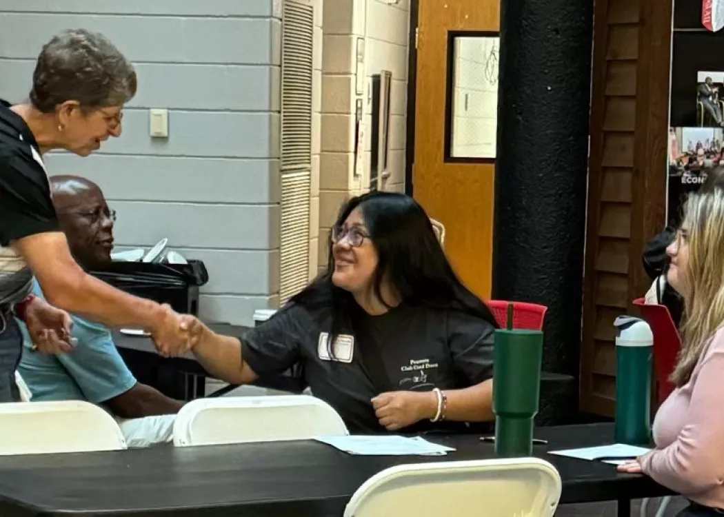 Professor Audrey Kline shaking a students hand