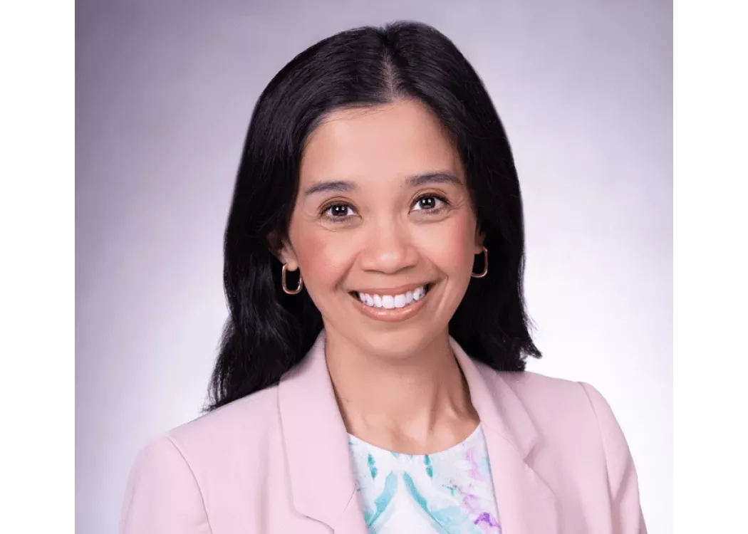 Kristina Cabanez in a pink blazer posing for headshot