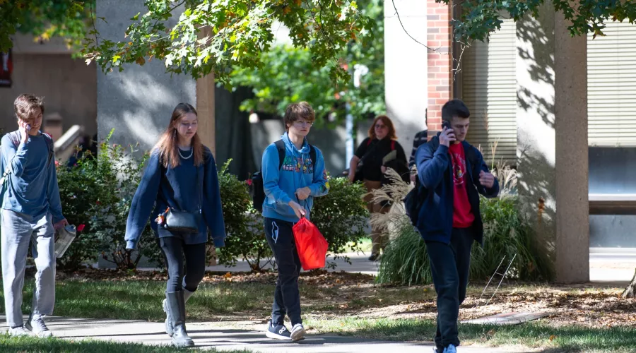 Group of students walking on campus in the fall.