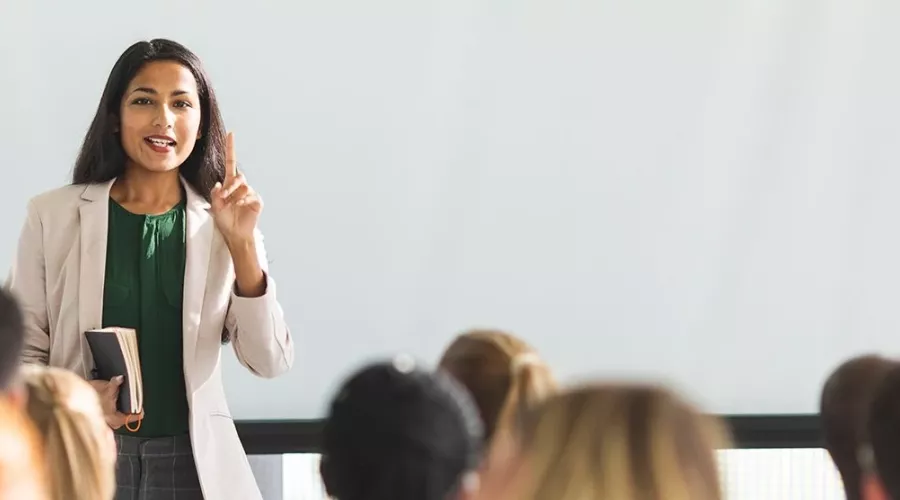 A woman in front of a classroom.