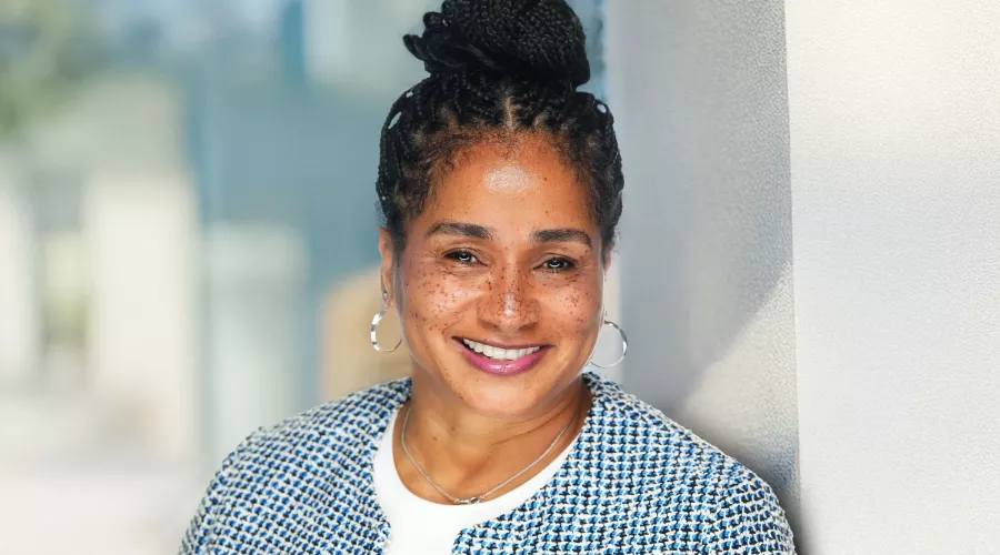 Woman in blue houndstooth blazer posing for headshot