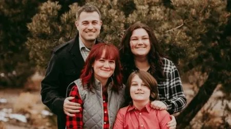 Family with two parents and two children posing for a photo