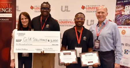 2025 Cardinal Challenge People’s Choice award winners Emmanuel Haynes and Golden Mashindi pose with Jackie Willmot and Gene Bajorinas, holding a large check for $5,000