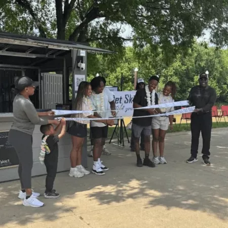 Golden Mashindi cutting the ribbon by river for Jet Ski 502 Grand Opening.